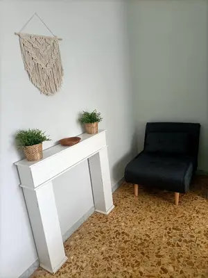 a living room with a chair and a white table at Domus Marco Aurelio in Rome