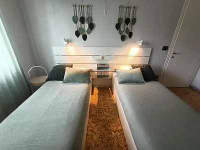 a small room with two beds and a table at Domus Marco Aurelio in Rome