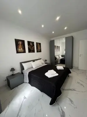 a bedroom with a large black bed in a room at Casa vacanze Flaminia in Rome