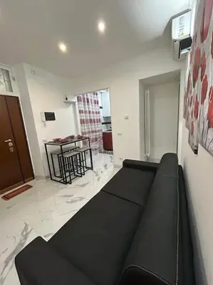 a living room with a black couch and a table at Casa vacanze Flaminia in Rome