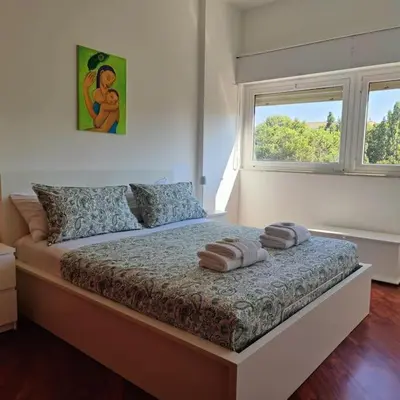 a bedroom with a bed with two towels on it at Culla di Diego BOX auto, Sospesi nel Cielo! in Rome
