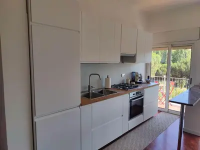 a kitchen with white cabinets and a sink at Culla di Diego BOX auto, Sospesi nel Cielo! in Rome