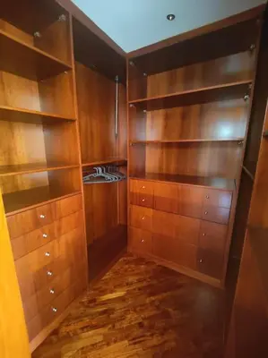 a kitchen with wooden cabinets and wooden floors at Culla di Diego BOX auto, Sospesi nel Cielo! in Rome