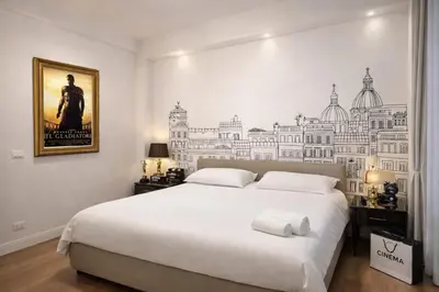 a hat sitting on top of a bed at TrastveRhome - House of Cinema in Rome