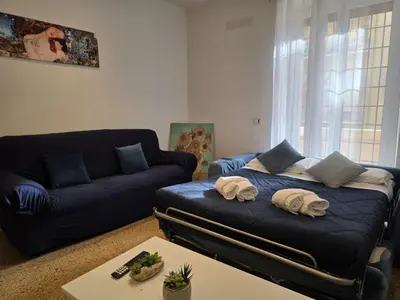 a living room with a blue couch and a blue couch at Be Your Home - Isabella Bright Apartment in Rome
