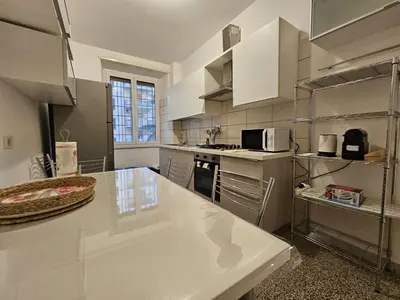 a kitchen with a white counter top in a kitchen at Be Your Home - Isabella Bright Apartment in Rome