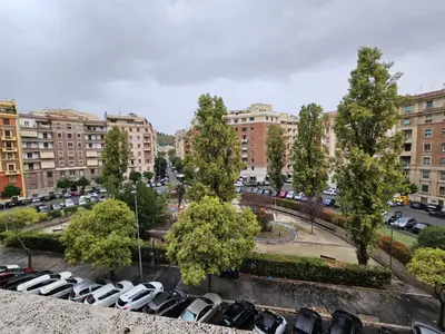 a parking lot full of cars in a city at Be Your Home - Isabella Bright Apartment in Rome