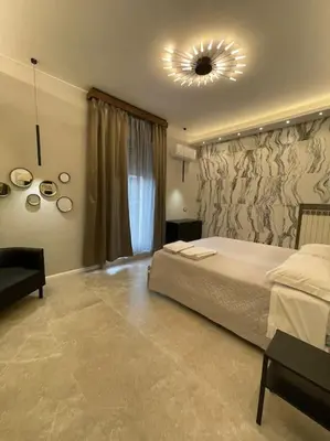 a bedroom with a large bed and a mirror at 2Effe apartment in Rome