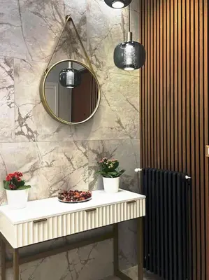 a bathroom with a mirror and a table with flowers at 2Effe apartment in Rome