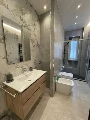 a bathroom with a sink and a toilet and a mirror at 2Effe apartment in Rome