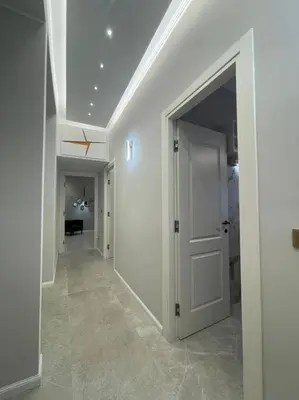 a hallway with white walls and an open door at 2Effe apartment in Rome