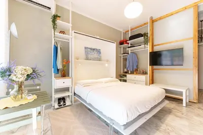 a bedroom with a large bed and a tv at Good Vibes Vaticano in Rome