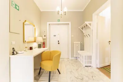 a bathroom with a desk and a yellow chair at Good Vibes Vaticano in Rome