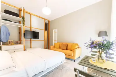 a bedroom with a bed and a couch at Good Vibes Vaticano in Rome