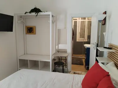 a bedroom with a bed and a mirror and a chair at Stanza Del Principe in Rome