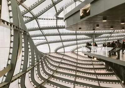 a spiral staircase in a building with people walking down it at Stanza Del Principe in Rome