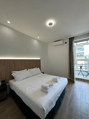 a bedroom with a large bed with towels on it at Domus house in Rome