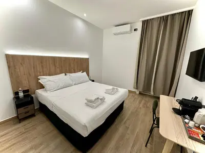 a bedroom with a bed with towels on it at Domus house in Rome