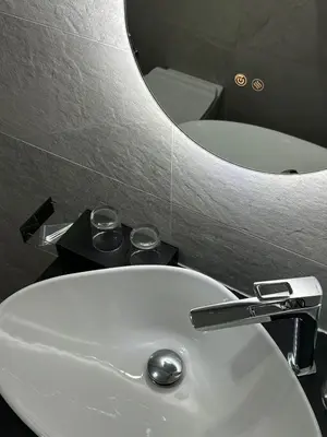 a bathroom sink with a faucet and a mirror at Domus house in Rome