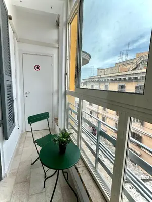 a room with a green table and a window at Domus house in Rome