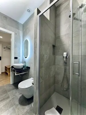 a bathroom with a shower and a toilet and a sink at Domus house in Rome