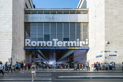 a crowd of people walking in front of a building at Domus house in Rome