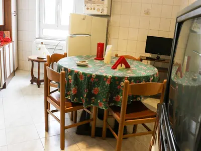 a kitchen with a table with a green table cloth at Casa Vacanze Scalone in Rome