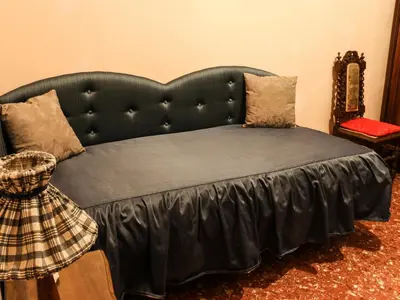 a bed with a black headboard in a room at Casa Vacanze Scalone in Rome