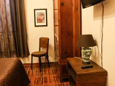 a bedroom with a table with a lamp and a chair at Casa Vacanze Scalone in Rome