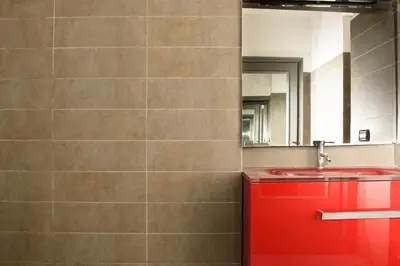 a bathroom with a red sink and a mirror at B&D Dolce Vita in Rome