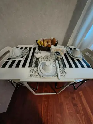 a table with plates and a bowl of food on a keyboard at Gregory B&B Vatican in Rome