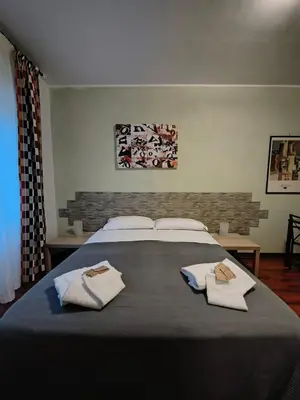 a bedroom with a large bed with towels on it at Gregory B&B Vatican in Rome