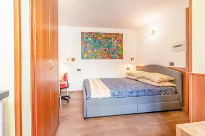 a bedroom with a bed and a painting on the wall at Tiny Steps to Piazza di Spagna in Rome