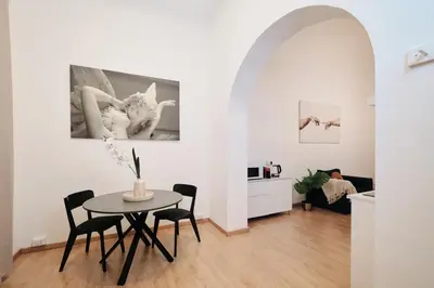 a dining room and living room with a table and chairs at 3' to Colosseum Bohèmien Paradise in Rome