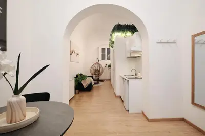 a white hallway with a table and a kitchen at 3' to Colosseum Bohèmien Paradise in Rome