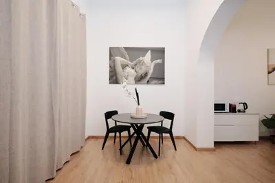 a dining room with a table and two chairs at 3' to Colosseum Bohèmien Paradise in Rome
