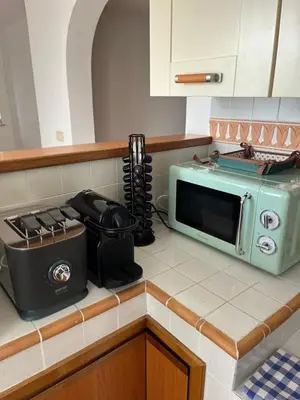 a kitchen counter with a toaster and a microwave at LaDolcevita - Ponte Milvio Stunning View Penthouse in Rome