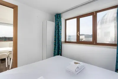 a room with a bed with a window and a sink at LaDolcevita - Ponte Milvio Stunning View Penthouse in Rome