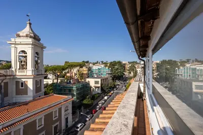 a view from the balcony of a building with a clock tower at LaDolcevita - Ponte Milvio Stunning View Penthouse in Rome