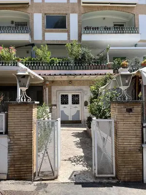 a house with a gate and a white door at LaDolcevita - Ponte Milvio Stunning View Penthouse in Rome