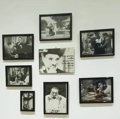 a wall with framed pictures offamous actors on it at Viale dei Re di Roma in Rome