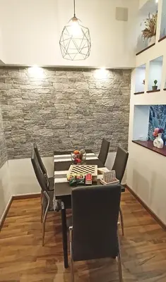 a dining room with a black table and chairs at Viale dei Re di Roma in Rome