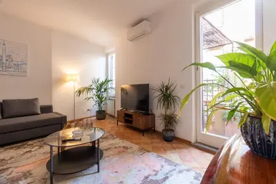 a living room with a couch and a tv at Terrazza Minerva in Rome