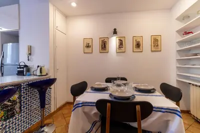 a dining room with a table and chairs at Terrazza Minerva in Rome
