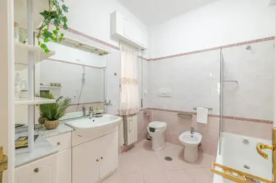 a bathroom with a sink and a toilet and a shower at Royal Vatican house JND in Rome
