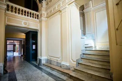 an empty hallway of a building with stairs at Imperial House in Rome