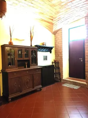 a room with a large wooden cabinet and a window at San Giovanni Loft in Rome