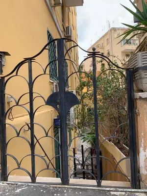 a black iron gate in front of a building at San Giovanni Loft in Rome