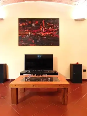 a coffee table in a room with a painting on the wall at San Giovanni Loft in Rome