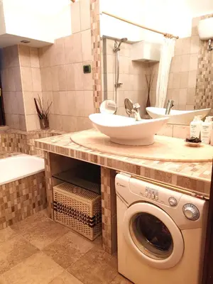 a bathroom with a sink and a washing machine at San Giovanni Loft in Rome